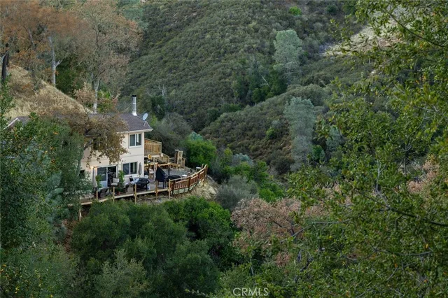 an aerial view of a house with swimming pool patio and outdoor seating