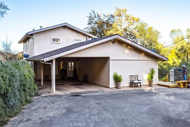 a view of a house with a yard and garage