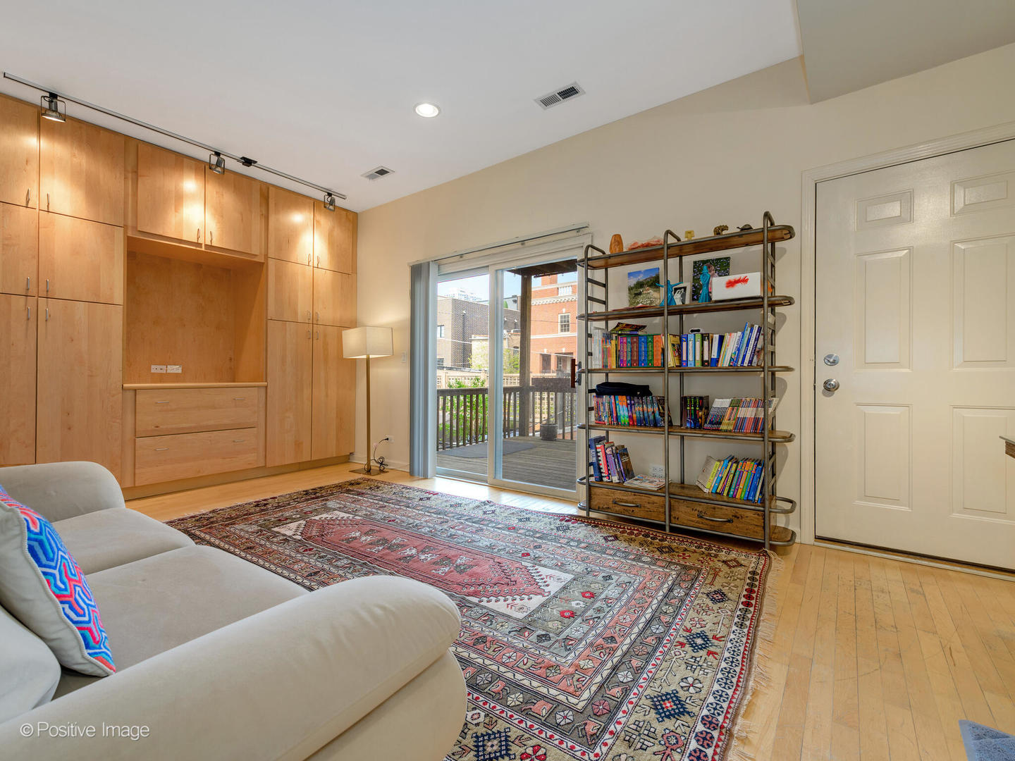 1829 North Mohawk Street, Unit 2N Chicago, IL 60614 - Photo 10 of 16 a living room with furniture a rug and a book shelf