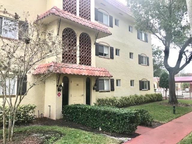 257 South Cypress Road, Unit 423 Pompano Beach, FL 33060 - Photo 1 of 38 a front view of a house with garden