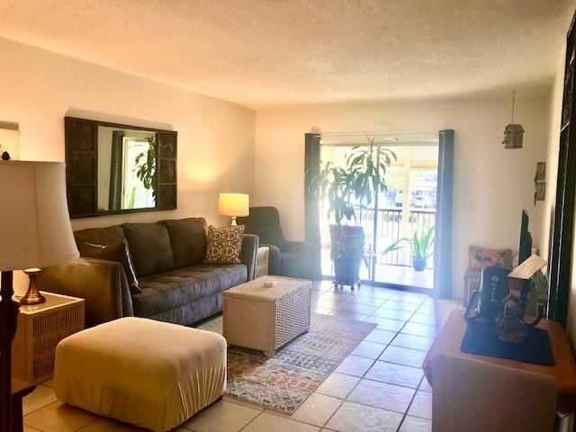 257 South Cypress Road, Unit 423 Pompano Beach, FL 33060 - Photo 11 of 38 a living room with furniture and a flat screen tv