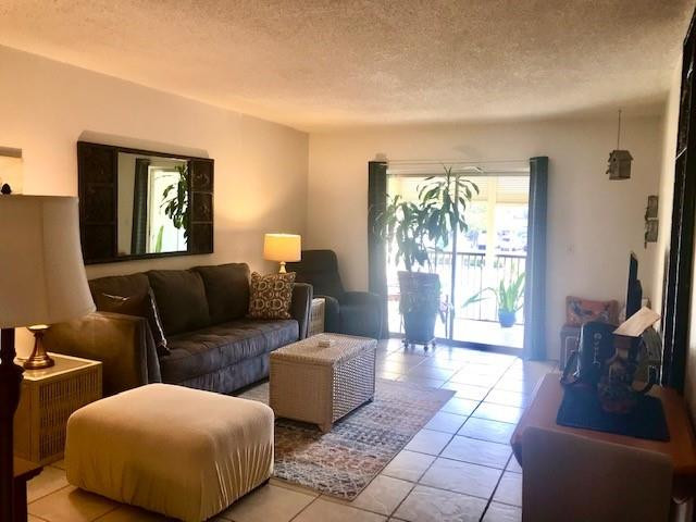 257 South Cypress Road, Unit 423 Pompano Beach, FL 33060 - Photo 12 of 38 a living room with furniture and a floor to ceiling window