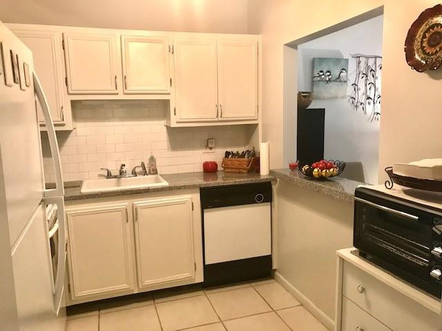 257 South Cypress Road, Unit 423 Pompano Beach, FL 33060 - Photo 13 of 38 a kitchen with a sink and a stove top oven
