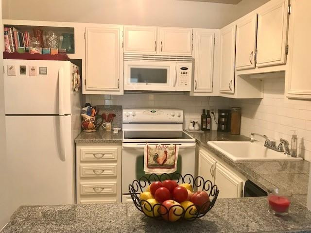 257 South Cypress Road, Unit 423 Pompano Beach, FL 33060 - Photo 14 of 38 a kitchen with stainless steel appliances granite countertop a sink stove and refrigerator