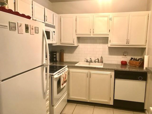 257 South Cypress Road, Unit 423 Pompano Beach, FL 33060 - Photo 15 of 38 a kitchen with stainless steel appliances granite countertop a sink and a refrigerator