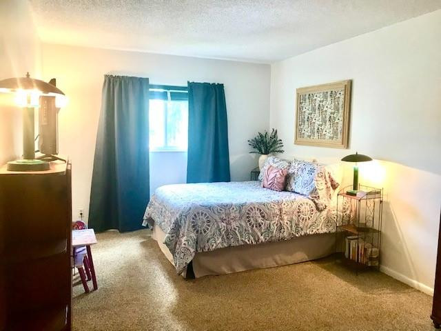257 South Cypress Road, Unit 423 Pompano Beach, FL 33060 - Photo 17 of 38 a bedroom with a bed and a lamp