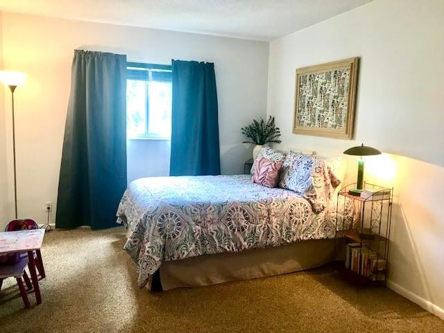257 South Cypress Road, Unit 423 Pompano Beach, FL 33060 - Photo 18 of 38 a bedroom with a bed and a table in it