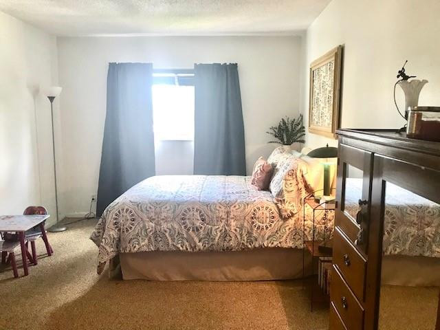 257 South Cypress Road, Unit 423 Pompano Beach, FL 33060 - Photo 19 of 38 a bedroom with a bed and wooden floor