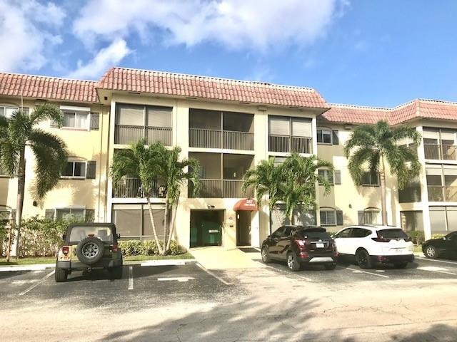 257 South Cypress Road, Unit 423 Pompano Beach, FL 33060 - Photo 2 of 38 a view of a car park in front of a building