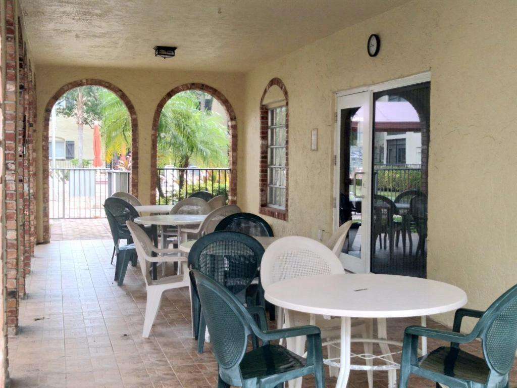 257 South Cypress Road, Unit 423 Pompano Beach, FL 33060 - Photo 27 of 38 a dining room with furniture a rug and wooden floor