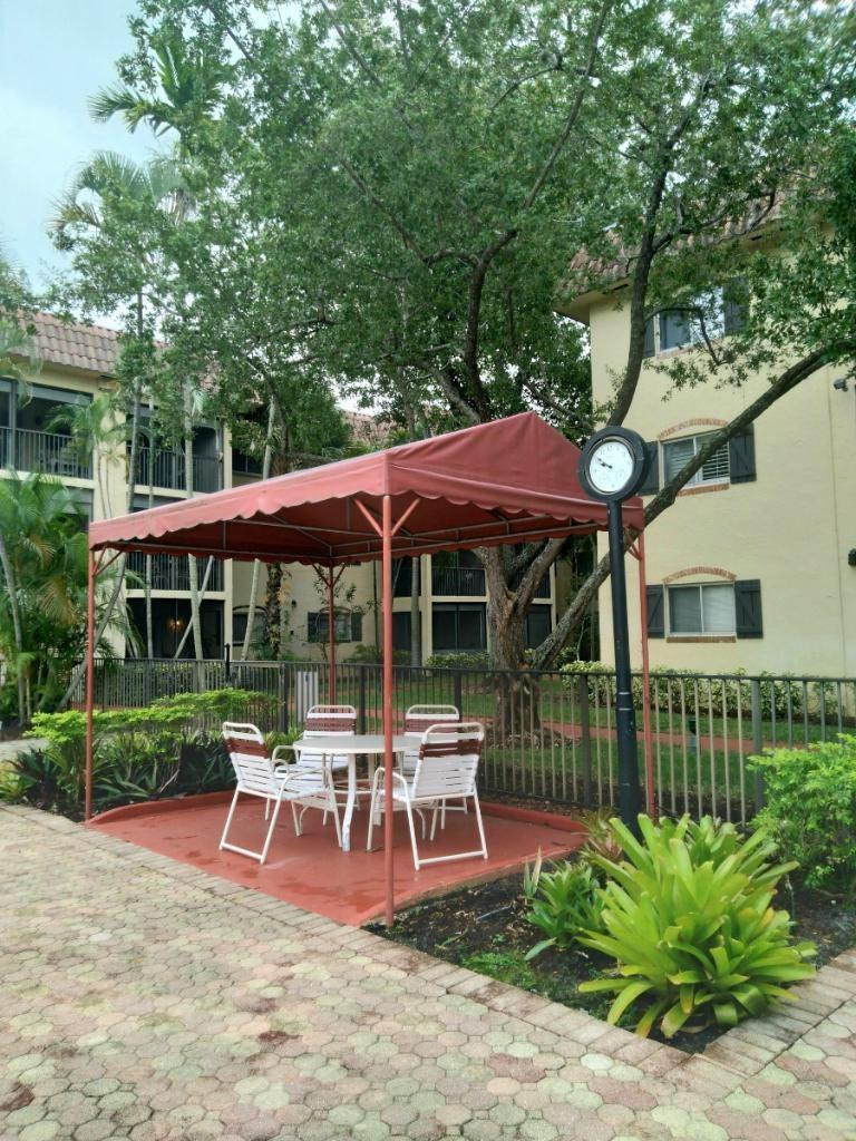 257 South Cypress Road, Unit 423 Pompano Beach, FL 33060 - Photo 28 of 38 a view of a house with backyard porch and sitting area