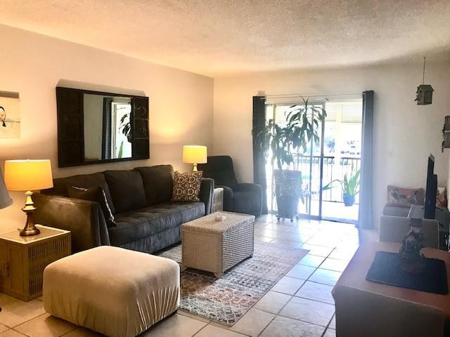 257 South Cypress Road, Unit 423 Pompano Beach, FL 33060 - Photo 3 of 38 a living room with furniture and a lamp