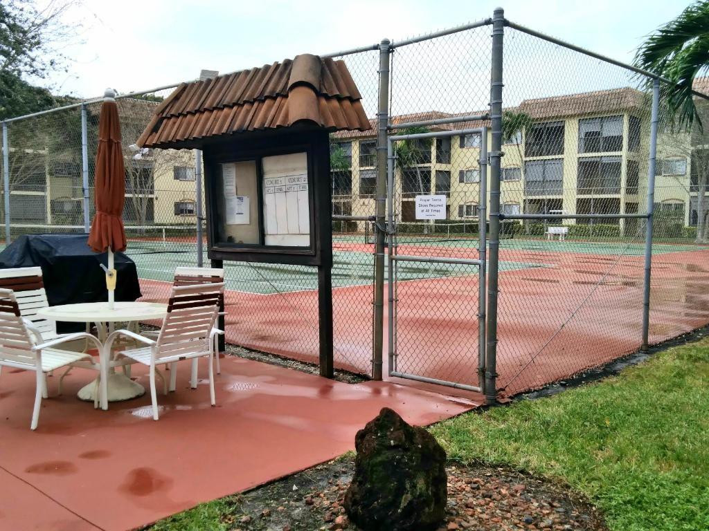 257 South Cypress Road, Unit 423 Pompano Beach, FL 33060 - Photo 36 of 38 a view of a house with backyard porch and sitting area