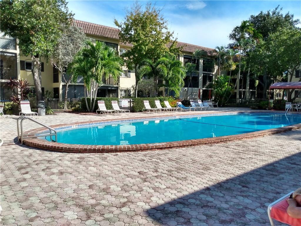 257 South Cypress Road, Unit 423 Pompano Beach, FL 33060 - Photo 37 of 38 a view of a house with a yard and sitting area