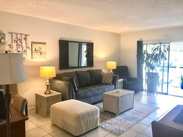 257 South Cypress Road, Unit 423 Pompano Beach, FL 33060 - Photo 4 of 38 a living room with furniture and a lamp