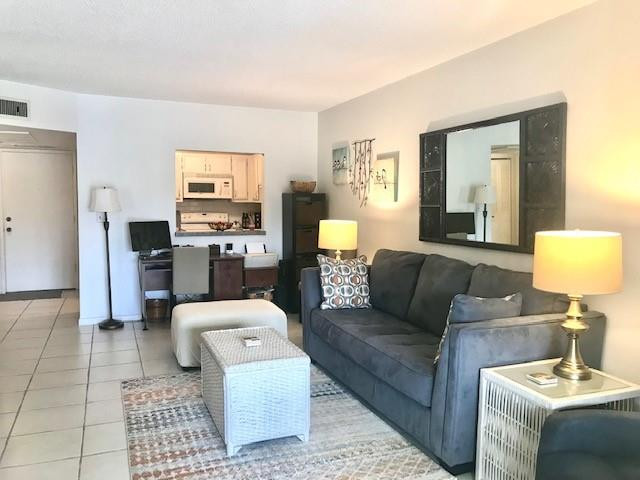 257 South Cypress Road, Unit 423 Pompano Beach, FL 33060 - Photo 5 of 38 a living room with furniture and a table