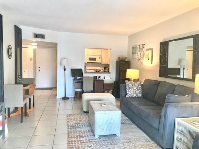 257 South Cypress Road, Unit 423 Pompano Beach, FL 33060 - Photo 6 of 38 a living room with furniture and a couch