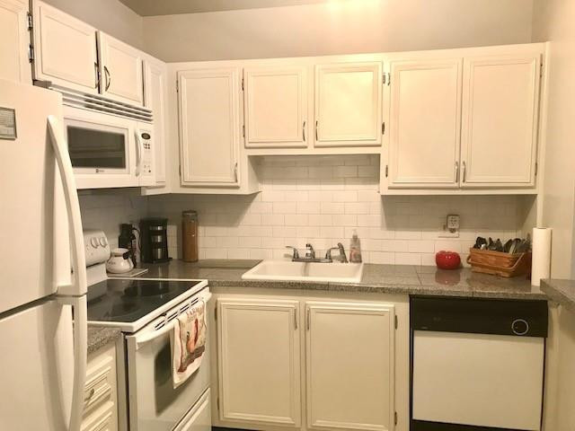 257 South Cypress Road, Unit 423 Pompano Beach, FL 33060 - Photo 10 of 38 a kitchen with stainless steel appliances granite countertop a sink and a white cabinets
