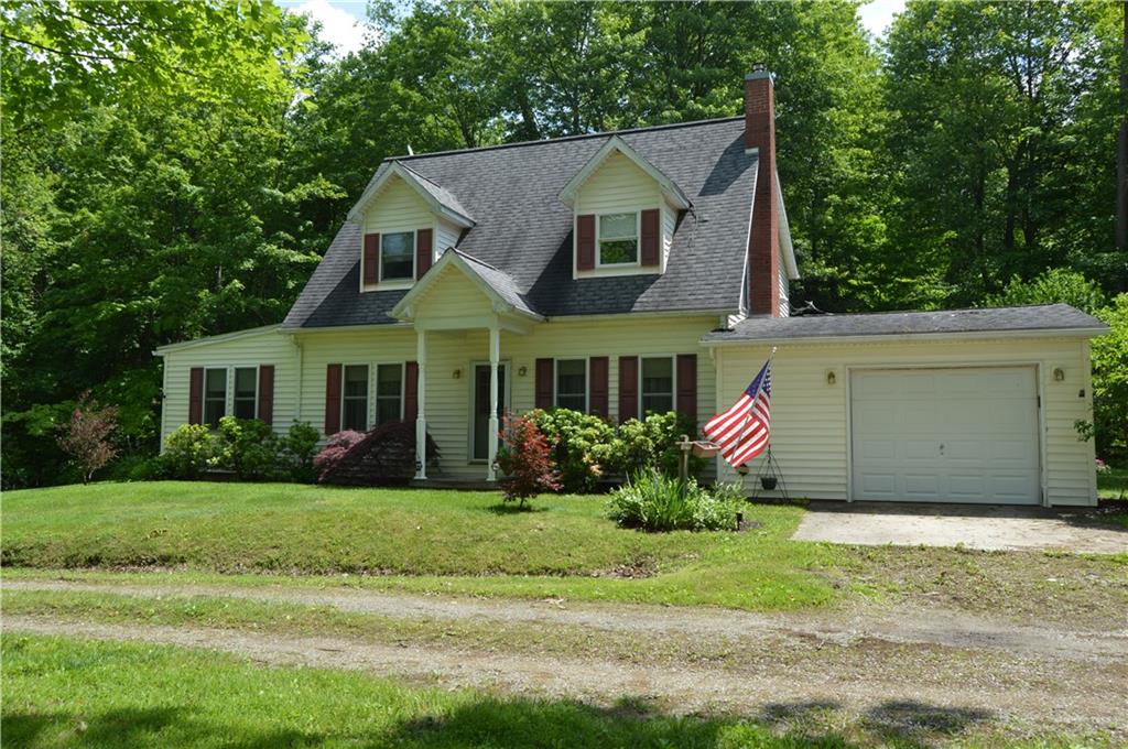 3244 Maple Lane Jamestown, PA 16134 - Photo 27 of 27 a front view of a house with a yard and garage