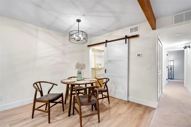 a view of a dining room with furniture wooden floor and a chandelier