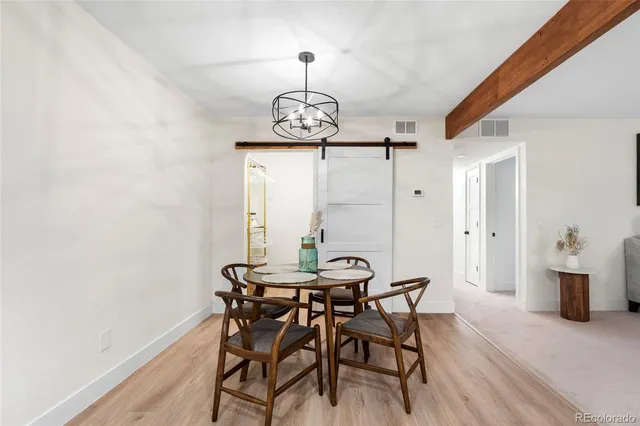 a dining room with furniture and wooden floor