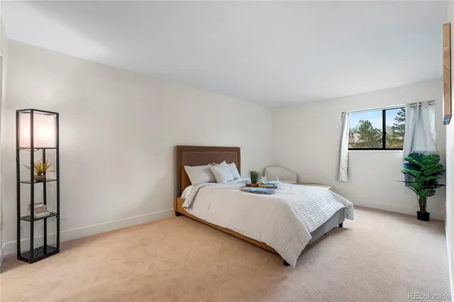a bed sitting in a bedroom next to a window