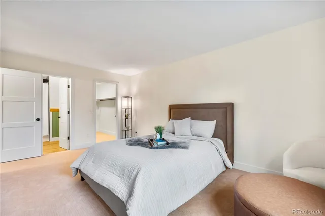 a bedroom with a bed and a couch