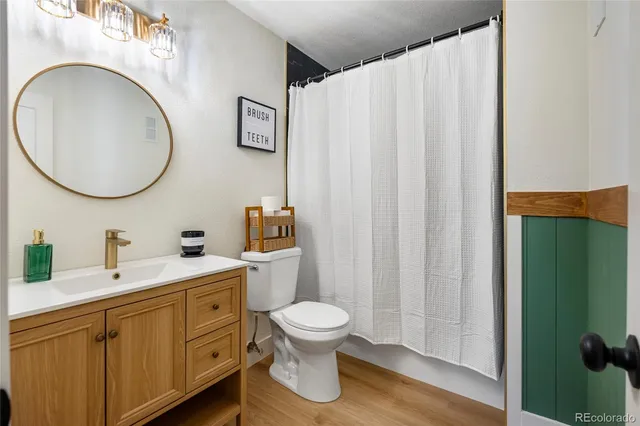 a bathroom with a toilet a sink and a mirror