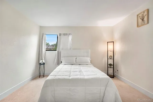 a bedroom with a bed and a mirror