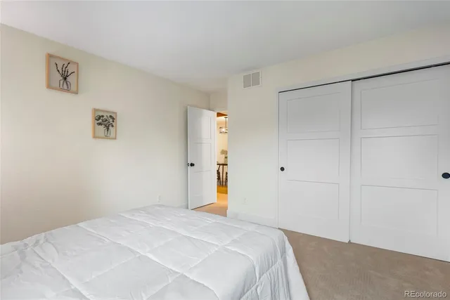 a bedroom with a bed and cabinets
