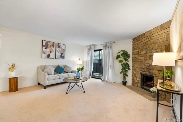 a living room with furniture a window and a fireplace
