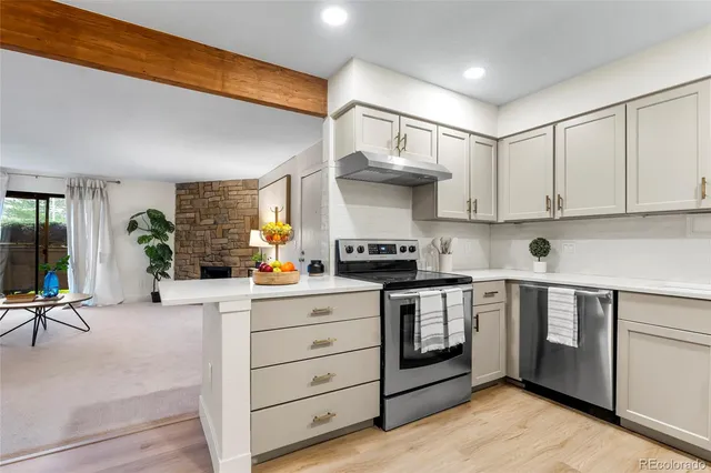 a kitchen with stainless steel appliances granite countertop a stove and cabinets