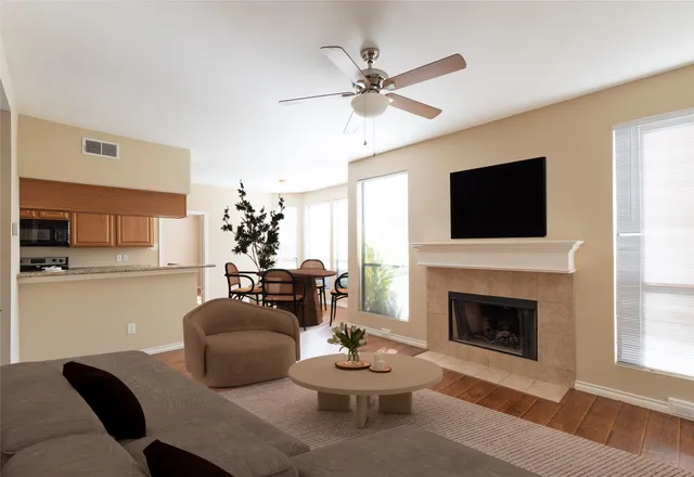 a living room with furniture a window and a fireplace
