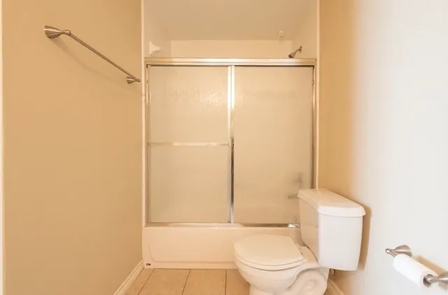 a white toilet sitting next to a bathroom sink