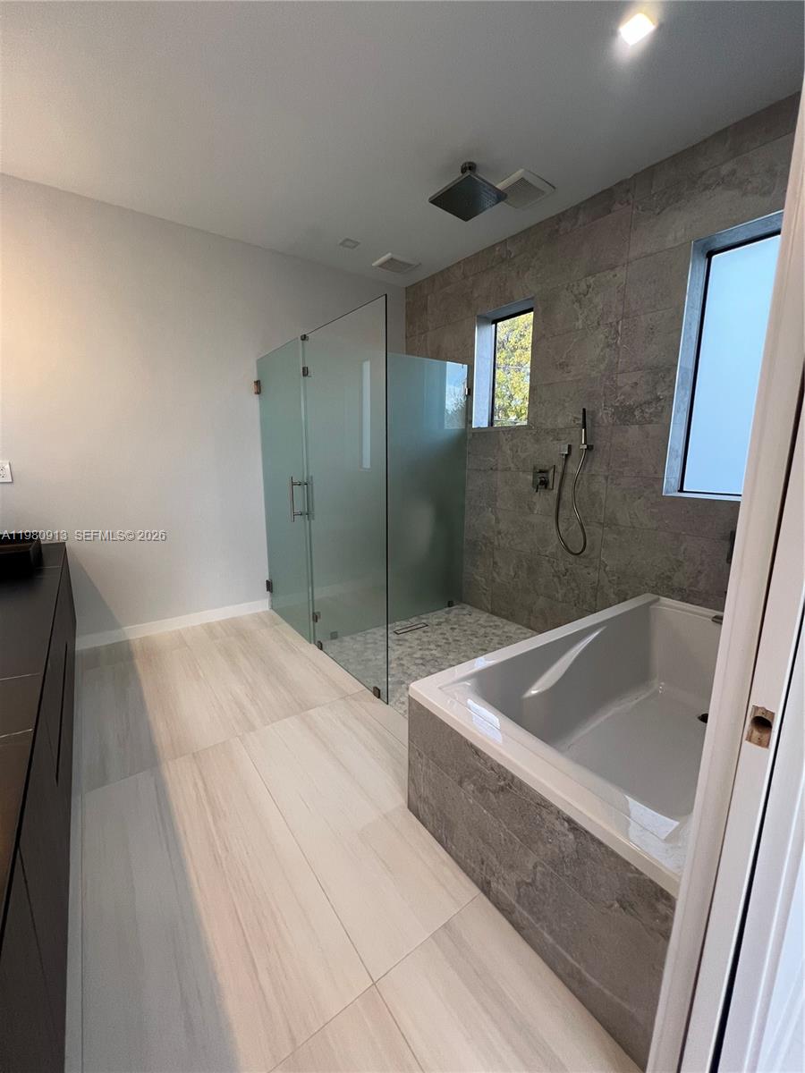 1533 Southwest 22nd Terrace Miami, FL 33145 - Photo 16 of 28 a spacious bathroom with a tub shower and sink