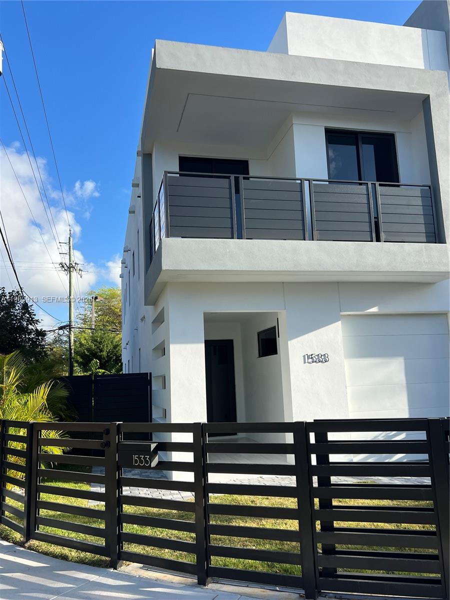 1533 Southwest 22nd Terrace Miami, FL 33145 - Photo 2 of 28 a front view of a house with a garden
