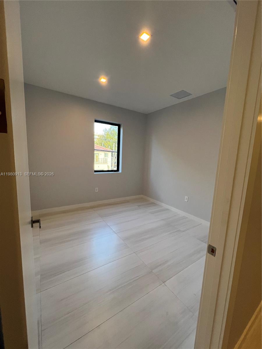 1533 Southwest 22nd Terrace Miami, FL 33145 - Photo 21 of 28 an empty room with wooden floor and windows