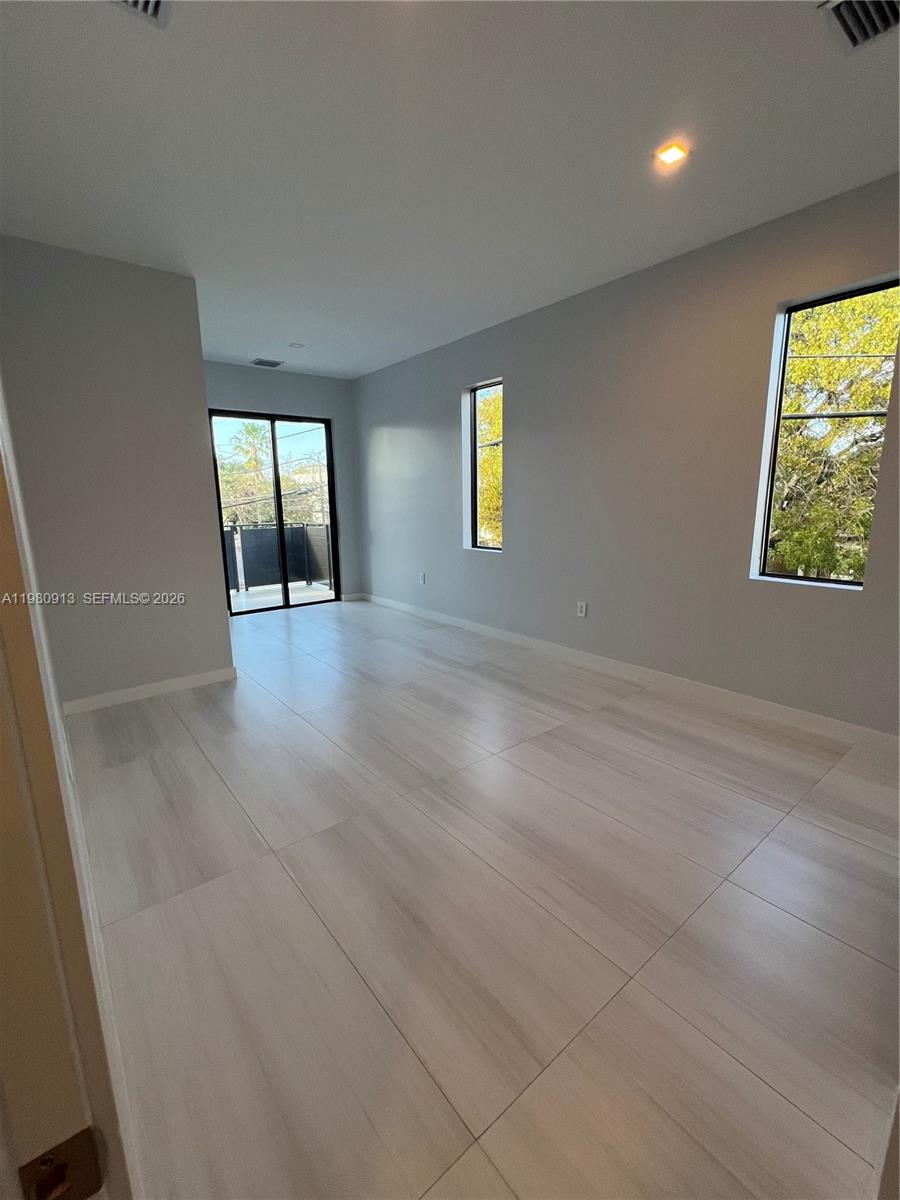 1533 Southwest 22nd Terrace Miami, FL 33145 - Photo 24 of 28 an empty room with window and wooden floor