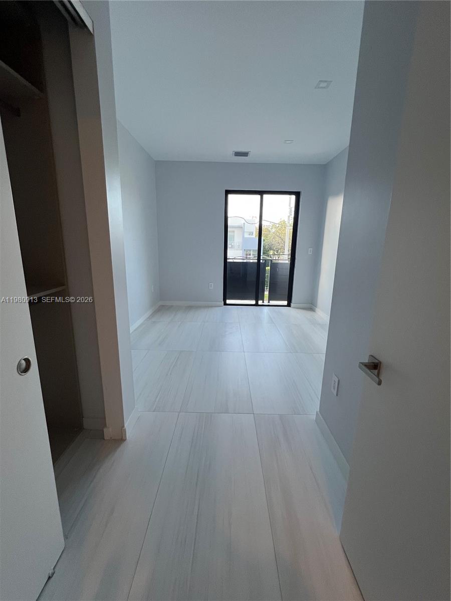 1533 Southwest 22nd Terrace Miami, FL 33145 - Photo 25 of 28 wooden floor in an empty room with a window