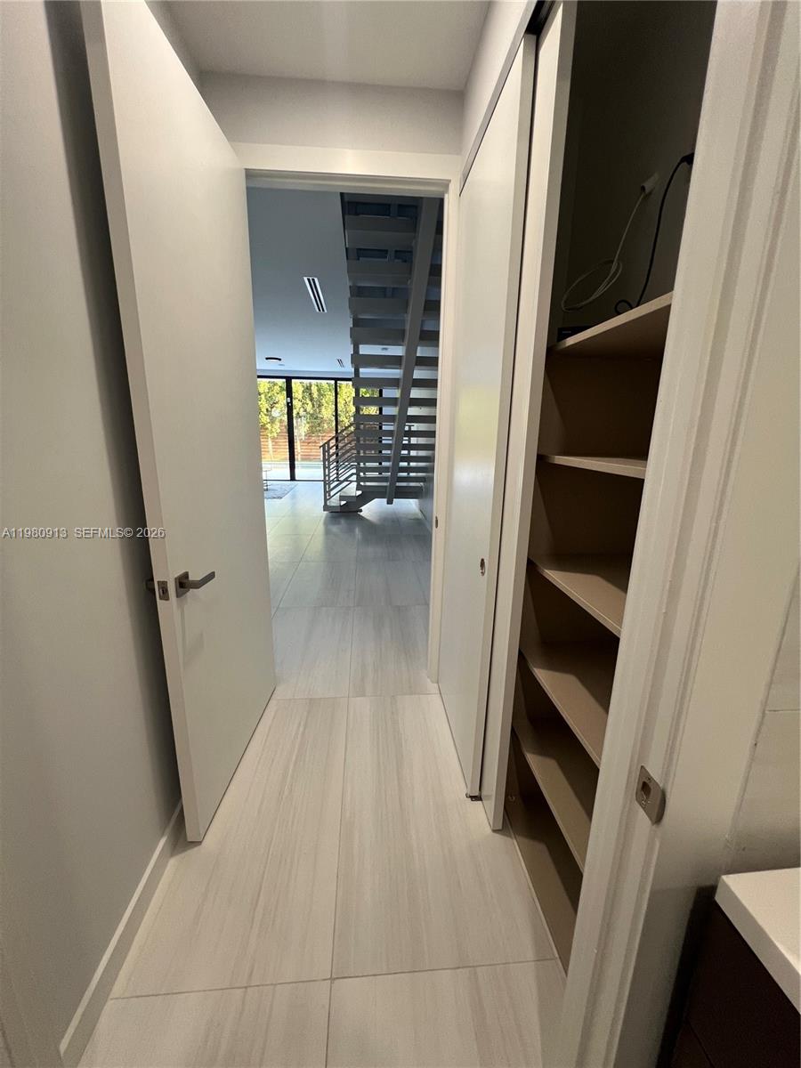1533 Southwest 22nd Terrace Miami, FL 33145 - Photo 27 of 28 a view of walk in closet with wooden floor and stairs