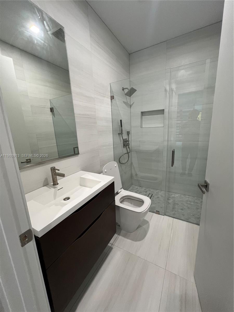 1533 Southwest 22nd Terrace Miami, FL 33145 - Photo 28 of 28 a bathroom with a sink a toilet and shower