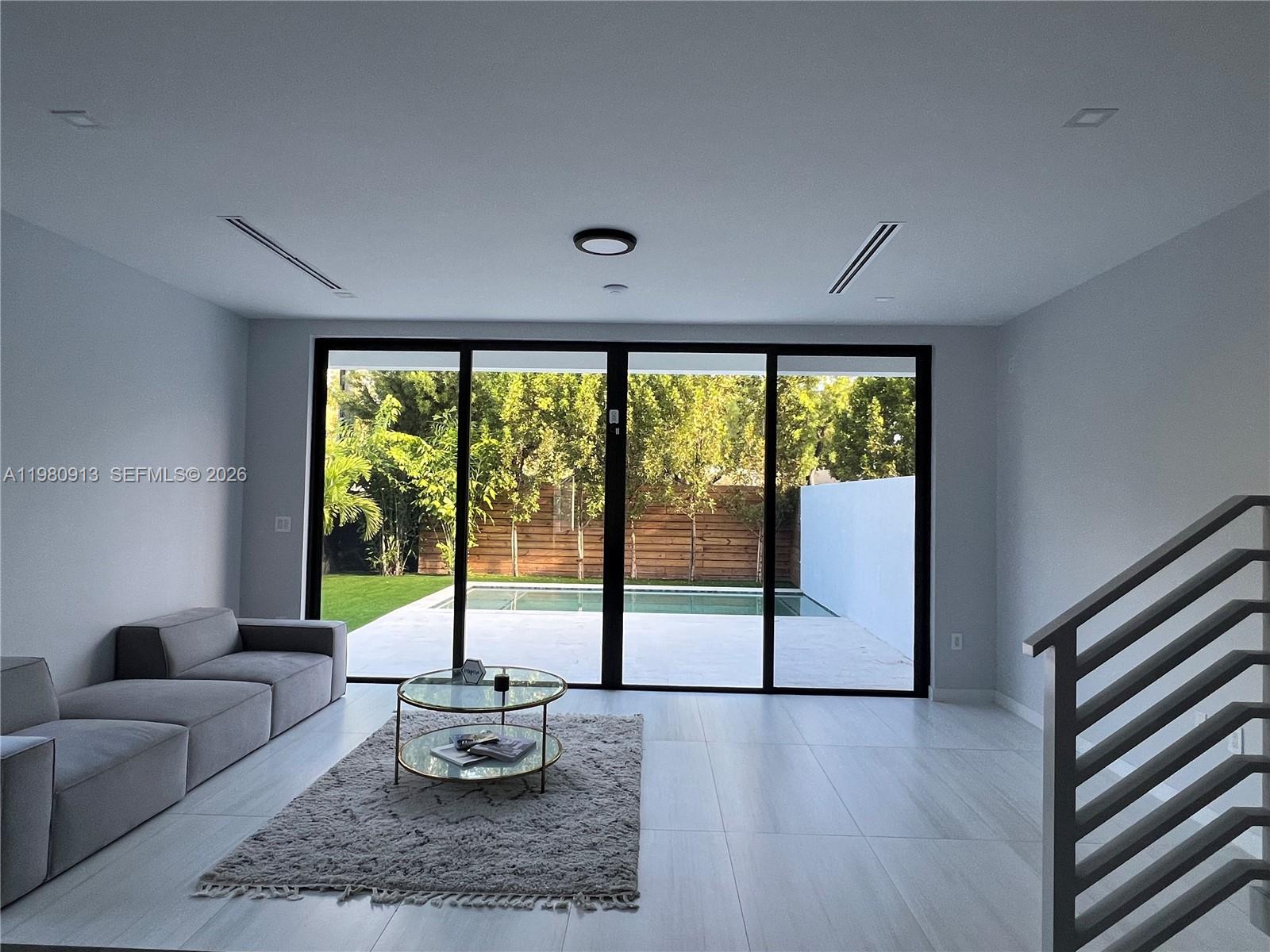 1533 Southwest 22nd Terrace Miami, FL 33145 - Photo 5 of 28 a living room with furniture and a large window