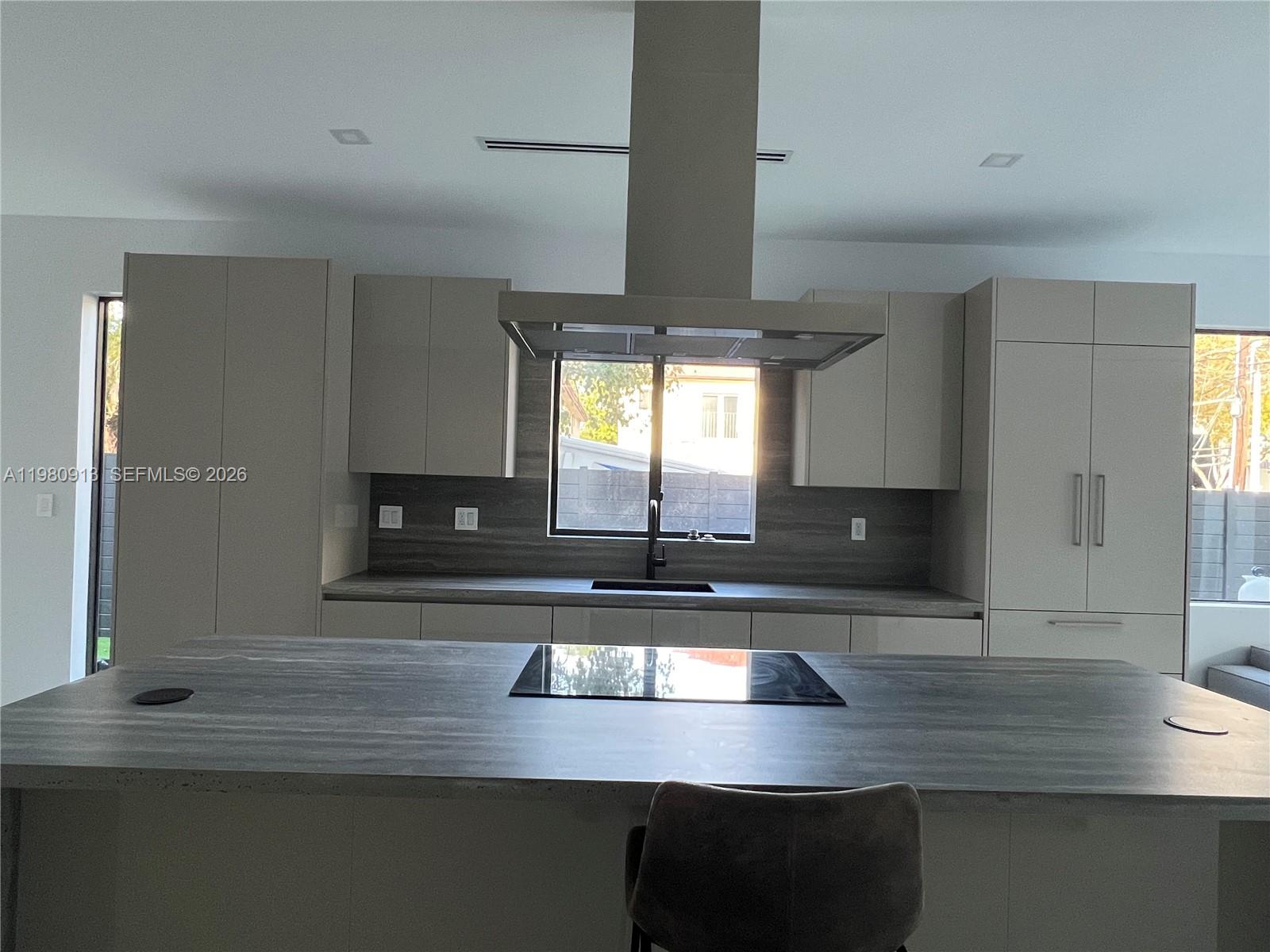 1533 Southwest 22nd Terrace Miami, FL 33145 - Photo 7 of 28 a kitchen with kitchen island a counter space and a window