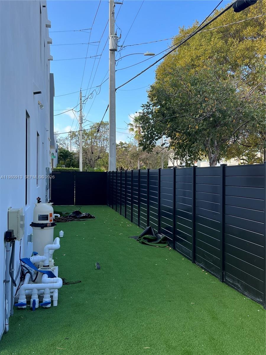 1533 Southwest 22nd Terrace Miami, FL 33145 - Photo 10 of 28 a view of a backyard with wooden fence and a bench