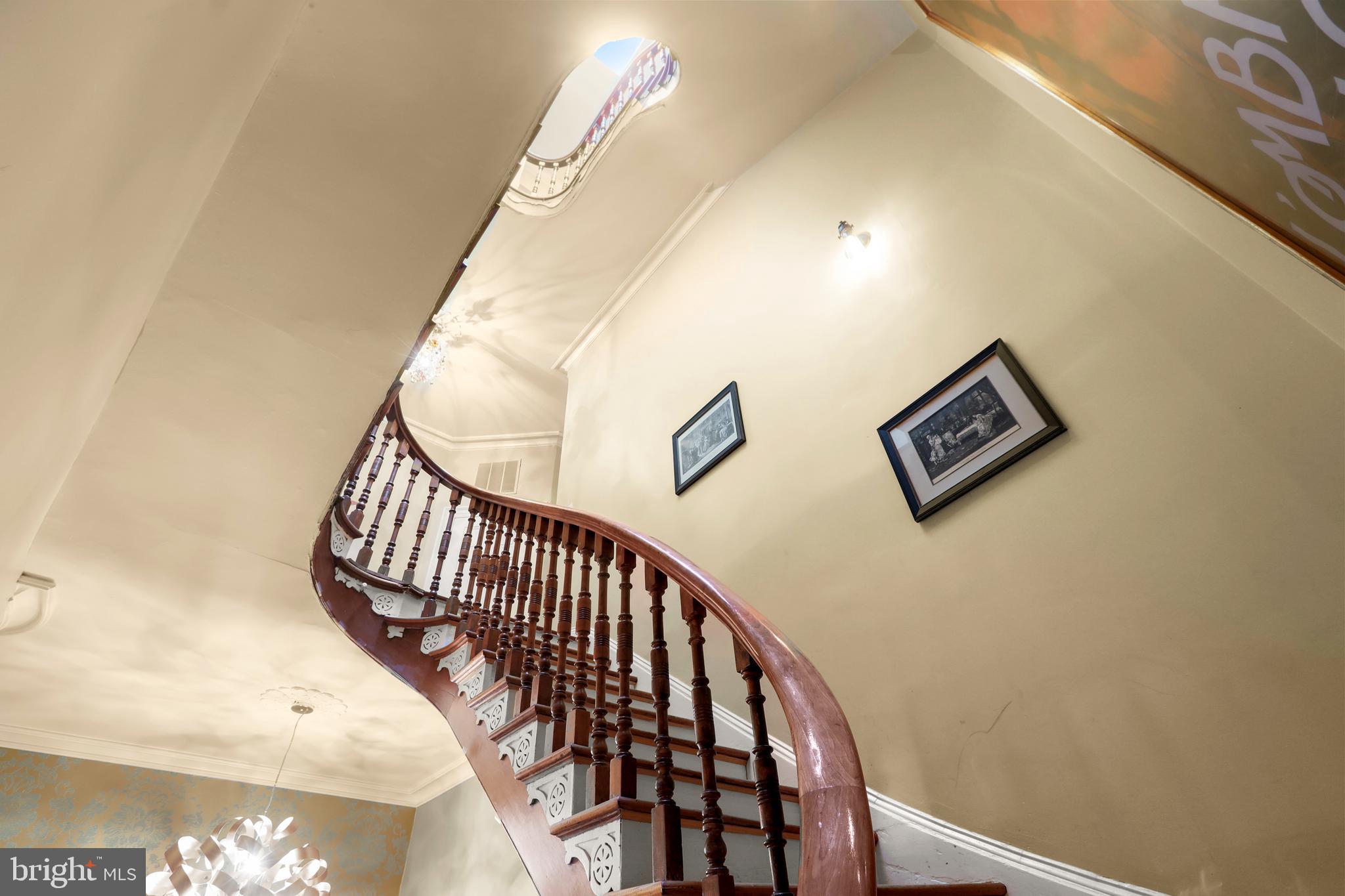 1007 North Calvert Street Baltimore, MD 21202 - Photo 13 of 43 a view of staircase with railing and white walls