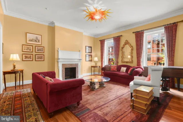 a living room with furniture fireplace and a large window
