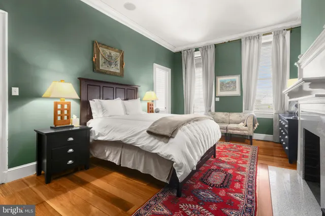 a bedroom with a bed and a lamp next to a window