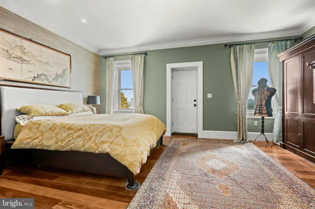 a spacious bedroom with a bed and a dresser