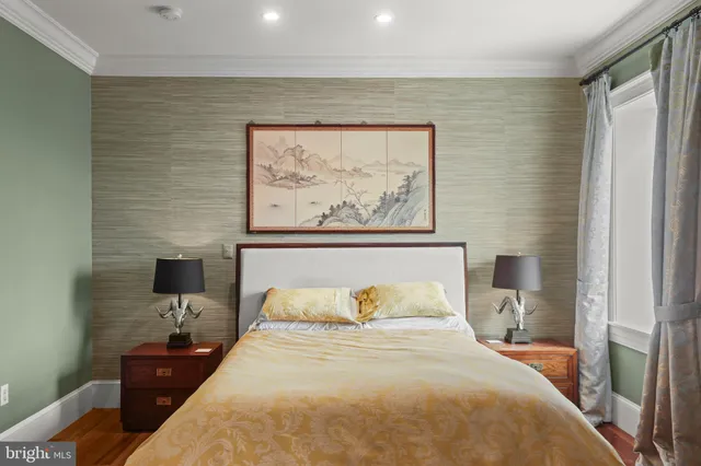 a bedroom with a bed and the painting on the wall