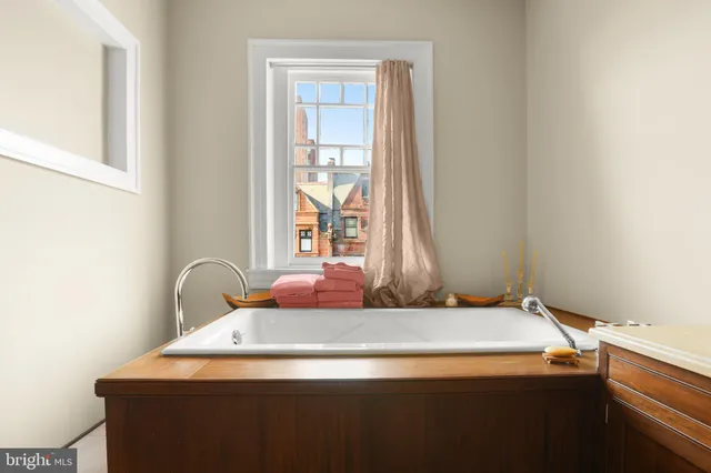 a view of a room that has a bed and a table in it